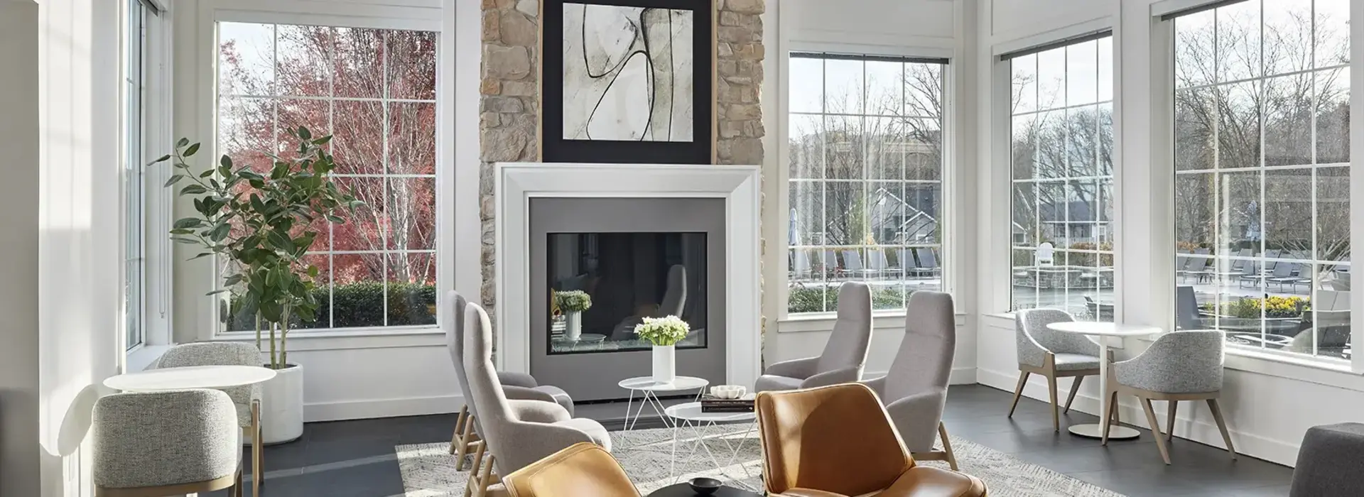 Large lounge with floor to ceiling windows, fireplace and seating at AV Malvern property