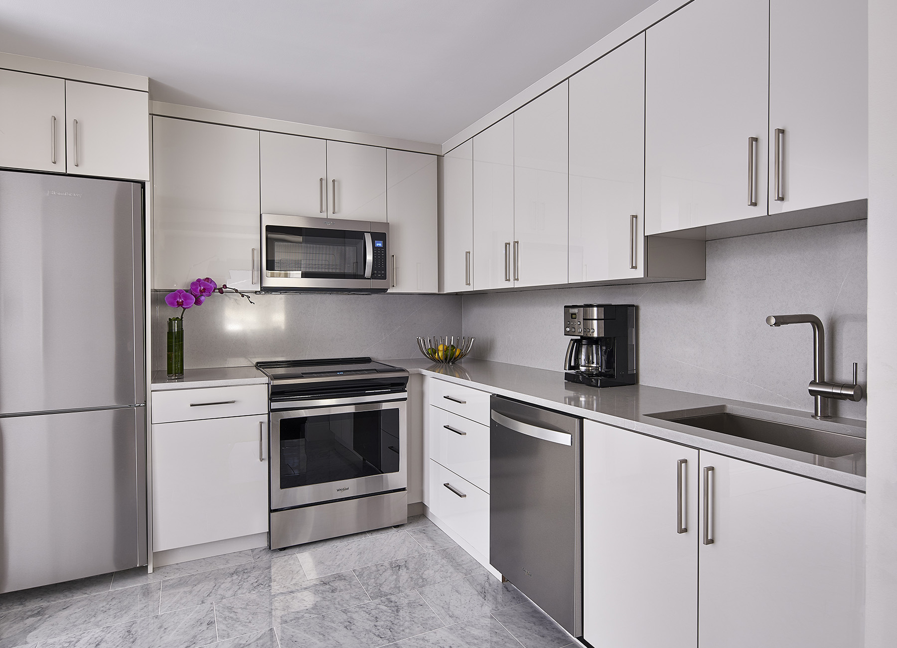 AKA Central Park furnished apartment kitchen with white countertops and full-sized appliances