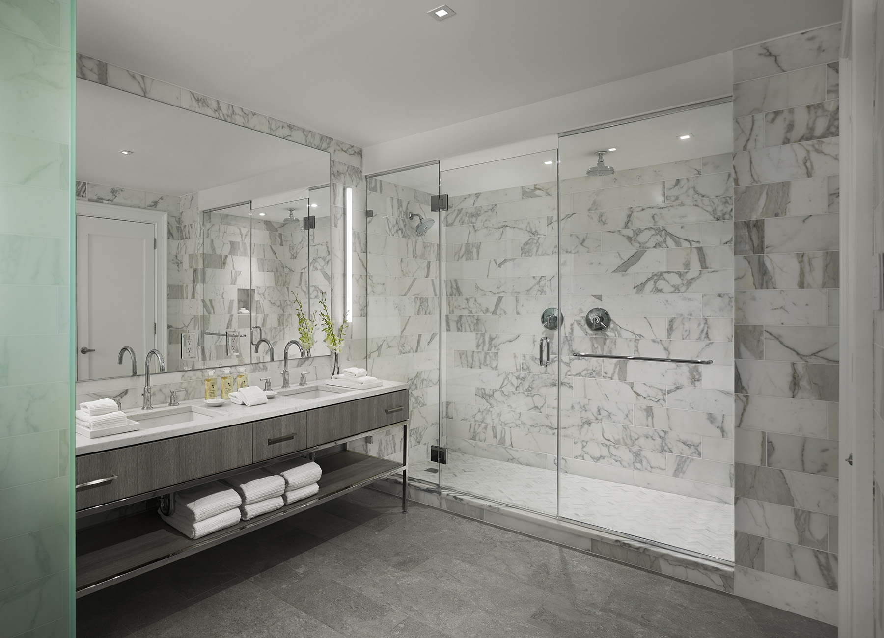 AKA Rittenhouse Square penthouse bathroom with gray marble finishes, vanity, and walk-in shower