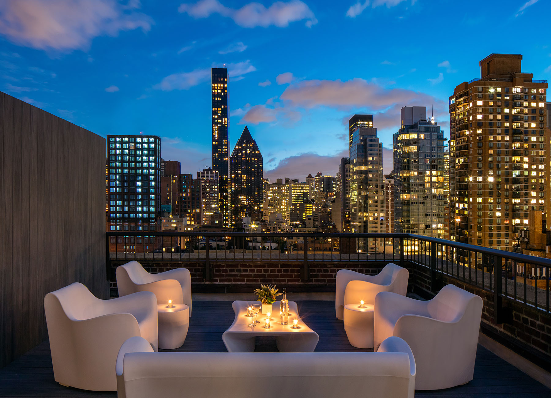 AKA Sutton Place penthouse exterior patio at dusk with views of the Manhattan skyline