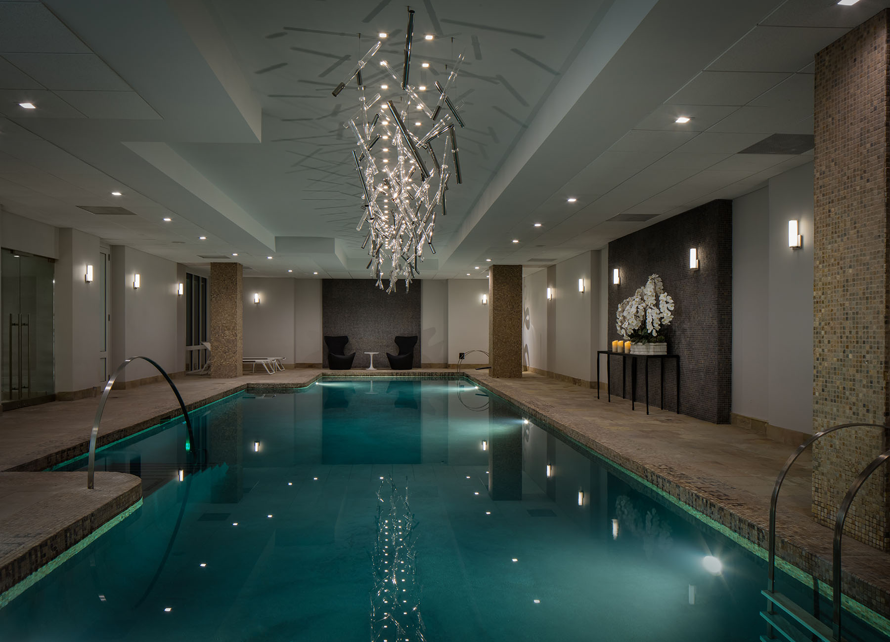 AKA Sutton Place luxury indoor pool with chrome lighting and marble accents