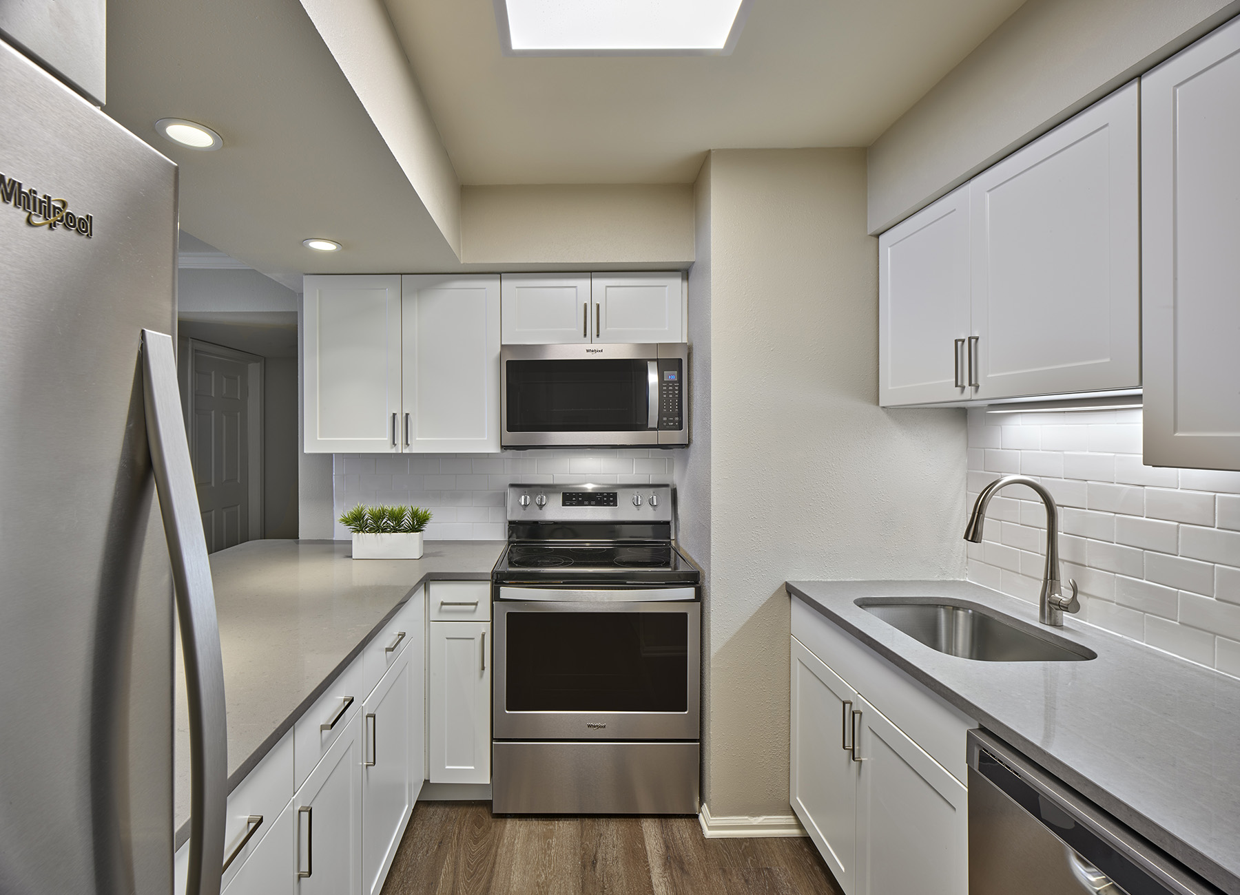 AVE Malvern apartment galley kitchen with white cabinets and stainless-steel appliances