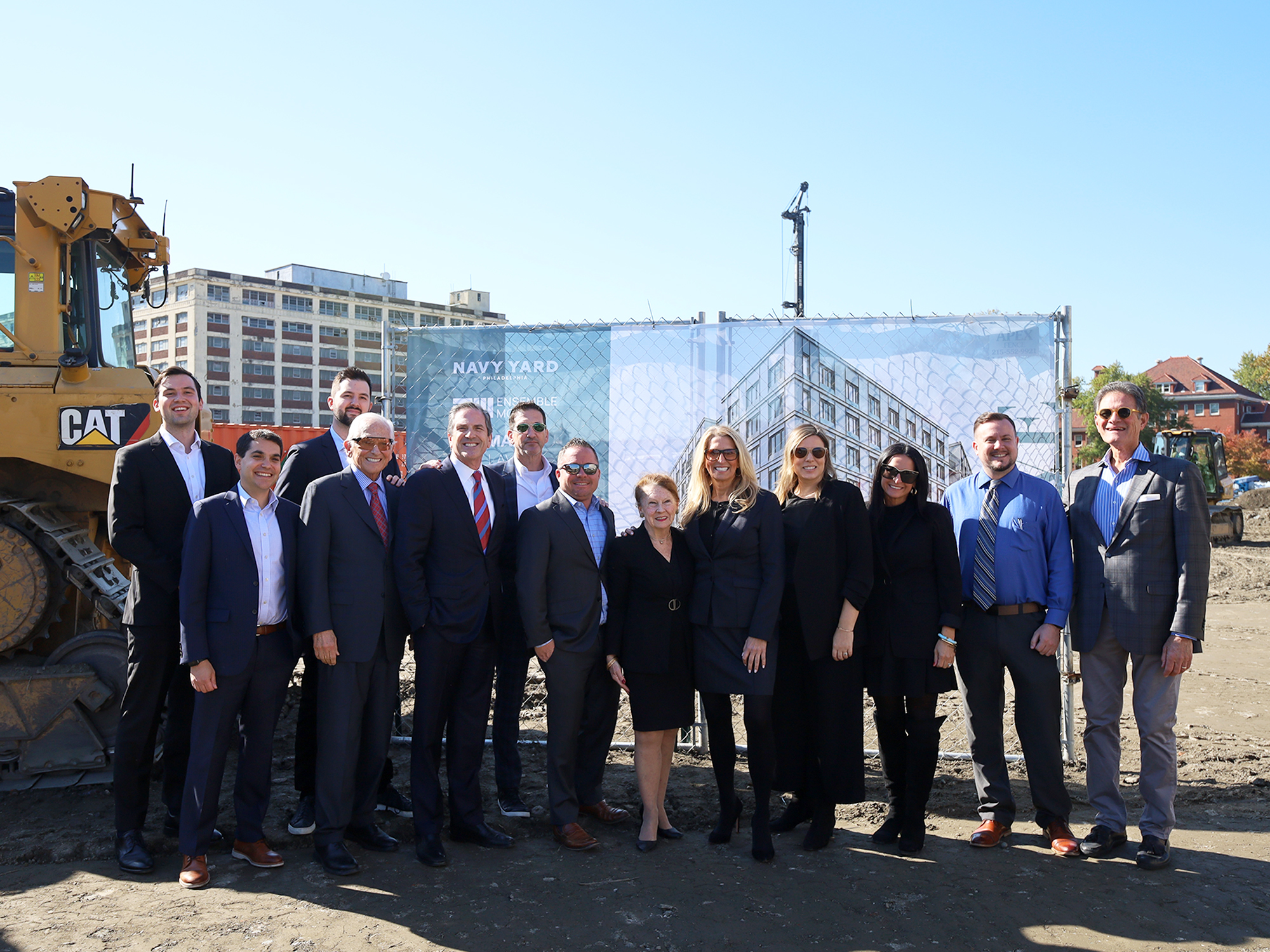 AVE Navy Yard groundbreaking team photo with image of future building in background