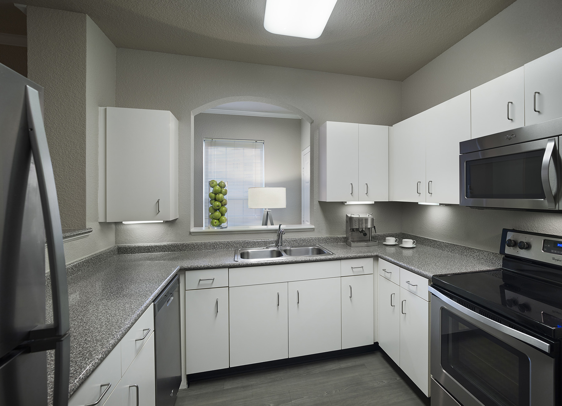 AVE Somerset apartment kitchen with white cabinets and full-sized appliances